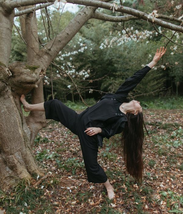 Woman performing a fluid yoga pose in a calm environment.